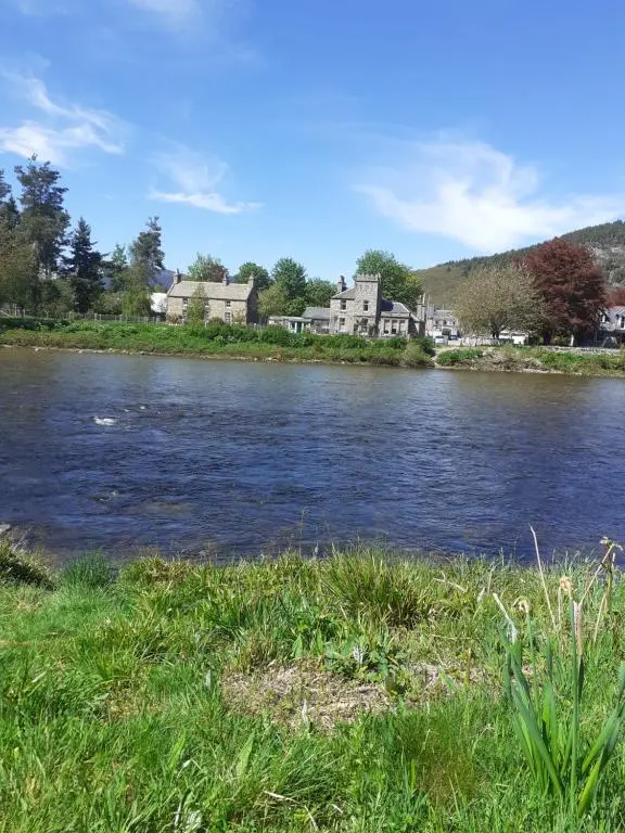 a body of water with houses in the background at Just off the Square... Ballater in Ballater