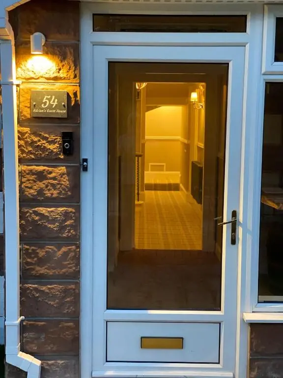 a front door of a house with a sign on it at Adrian's Guest House in Inverness