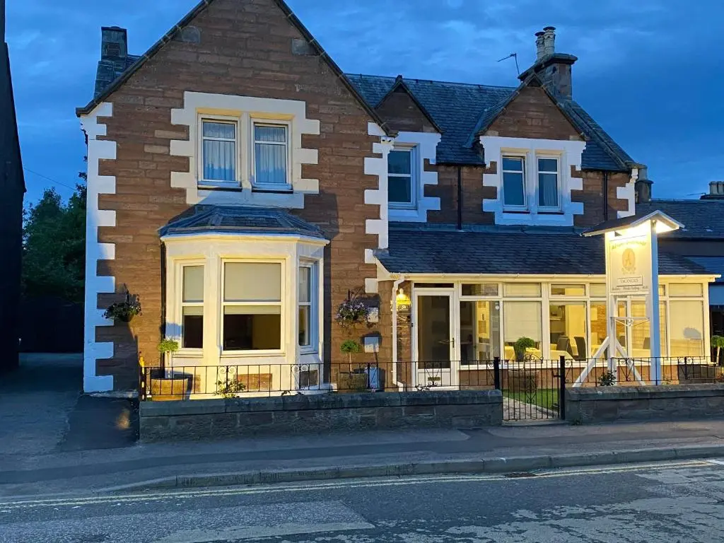 a house on a street in front of a street at Adrian's Guest House in Inverness