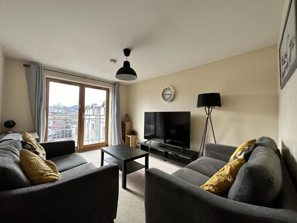 a living room with two couches and a television at Waterside View Apartment in Inverness