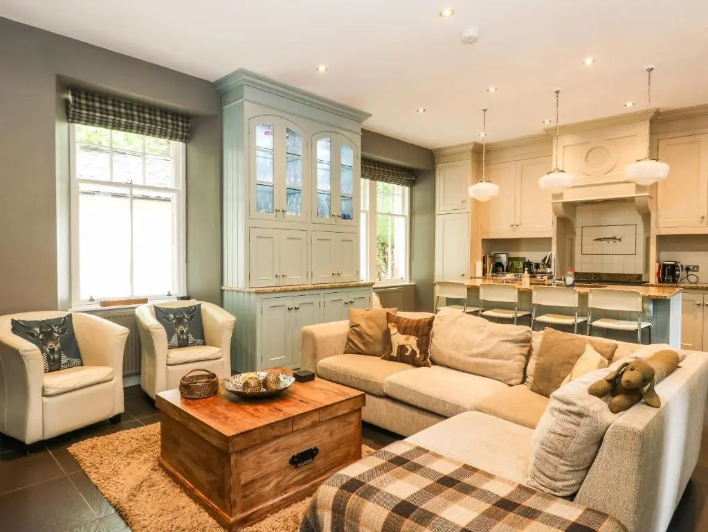 a living room with two couches and a table at Bearnock Lodge in Inverness