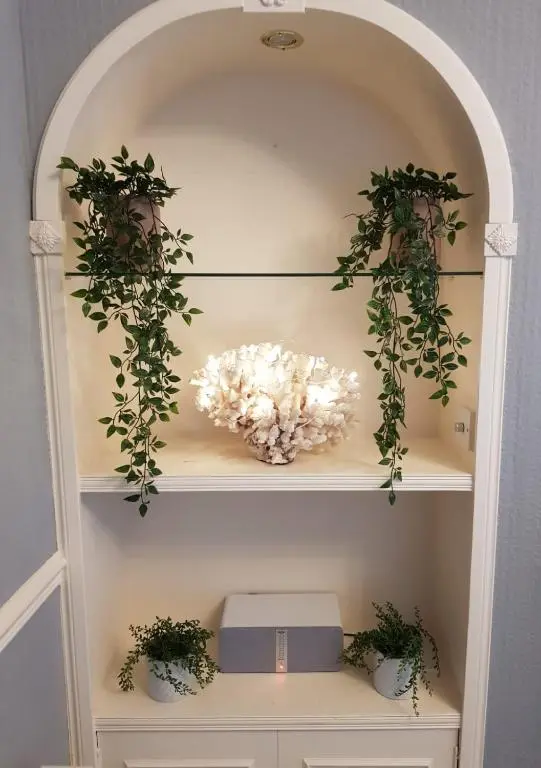 a shelf with plants and flowers on it at Glencoe House Inverness in Inverness