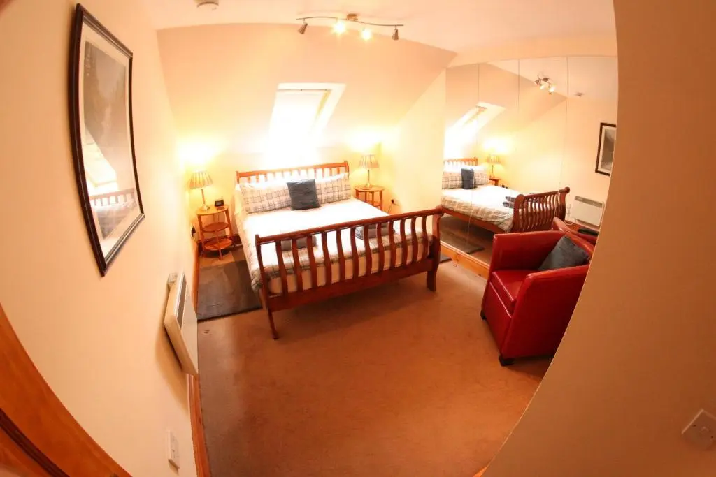 a view of a living room with a bed and a couch at Macallen in Nairn