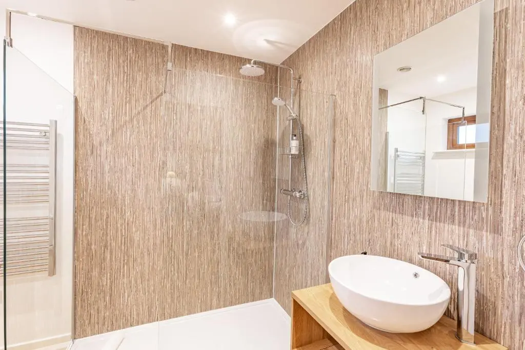 a bathroom with a white sink and a shower at Thistle Lodge 21 with Hot Tub in Belladrum