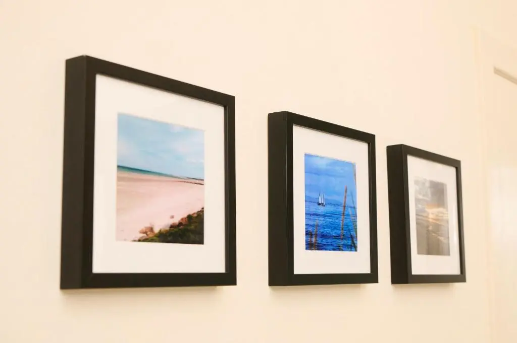 three framed pictures hanging on a wall at Monkland Cottage in Nairn