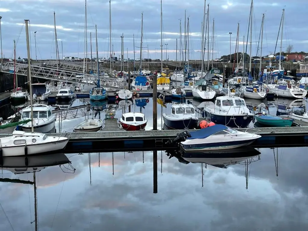 a bunch of boats are docked in a marina at Monkland Cottage in Nairn