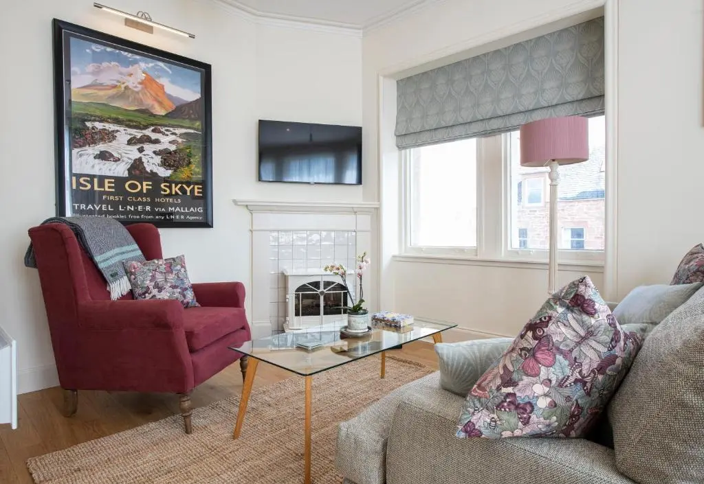 a living room with a couch and a table at Art House Apartments in Inverness