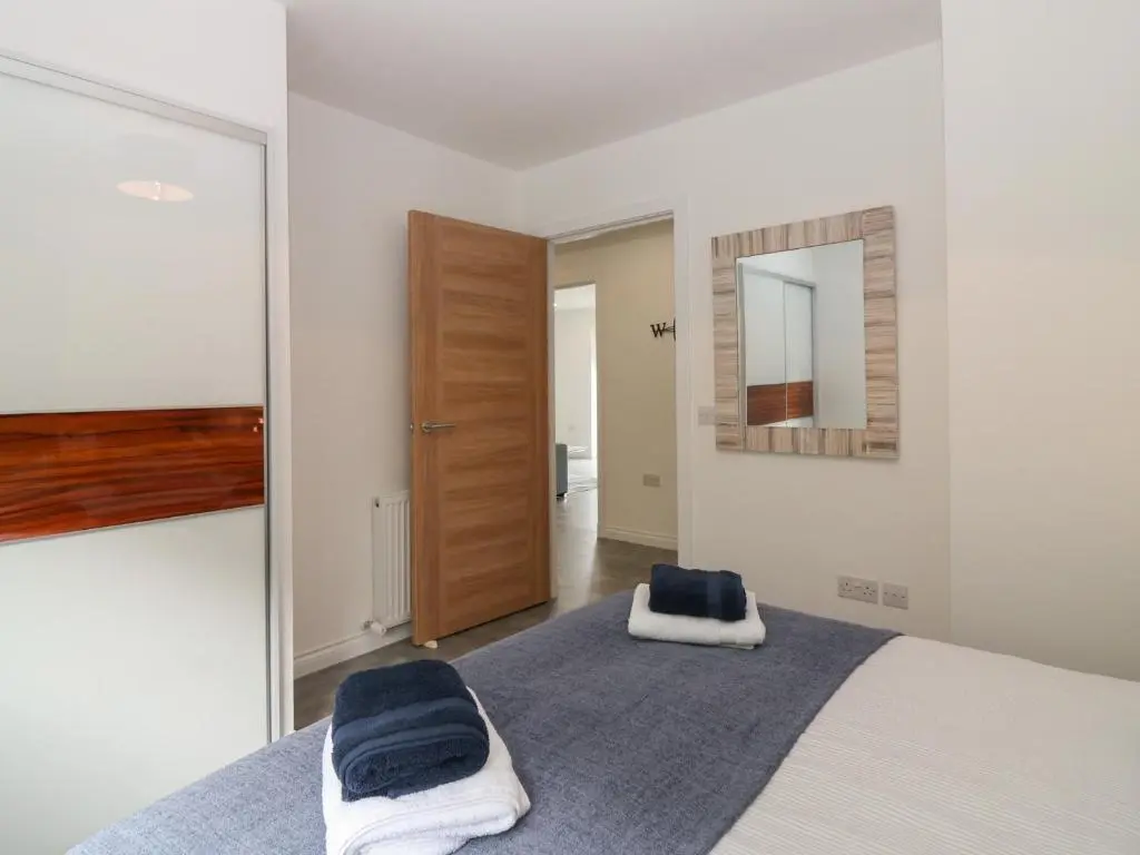 a bedroom with a bed and a mirror at Ocean View in Banff