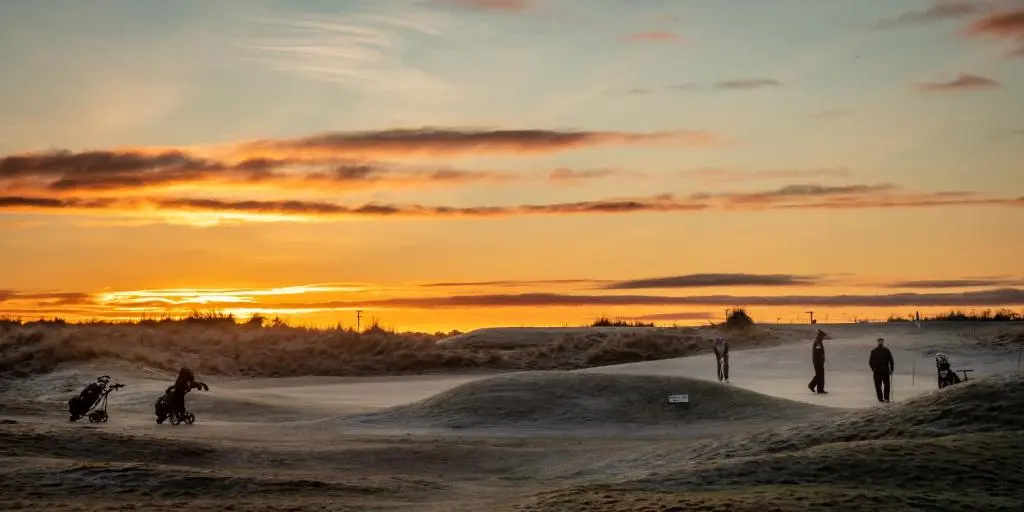 a group of people riding horses in the sand at sunset at Contemporary One Bedroom Apartment Close To All Amenities In Conservation Area in Tain