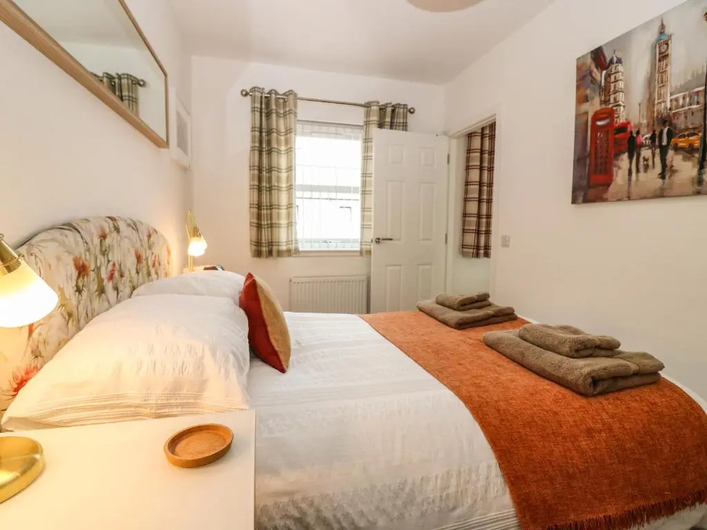 a bedroom with two beds with towels on it at 38 The Views in Elgin