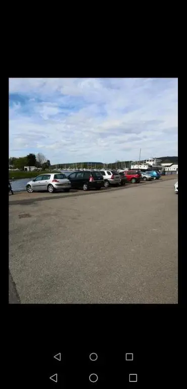 a group of cars parked in a parking lot at Great Glen Way Canal Side Apartment in Inverness