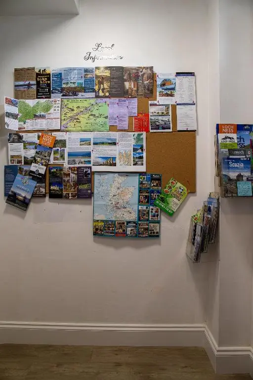a wall with a bunch of signs on a wall at Great Glen Way Canal Side Apartment in Inverness