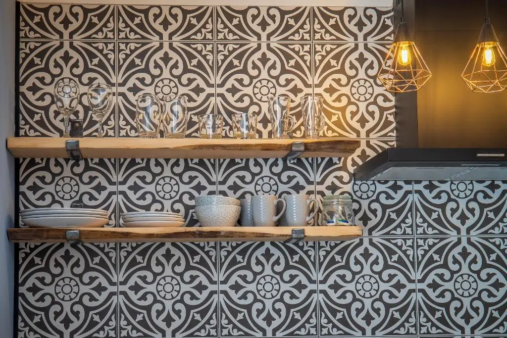 a kitchen with a black and white patterned wall at Great Glen Way Canal Side Apartment in Inverness