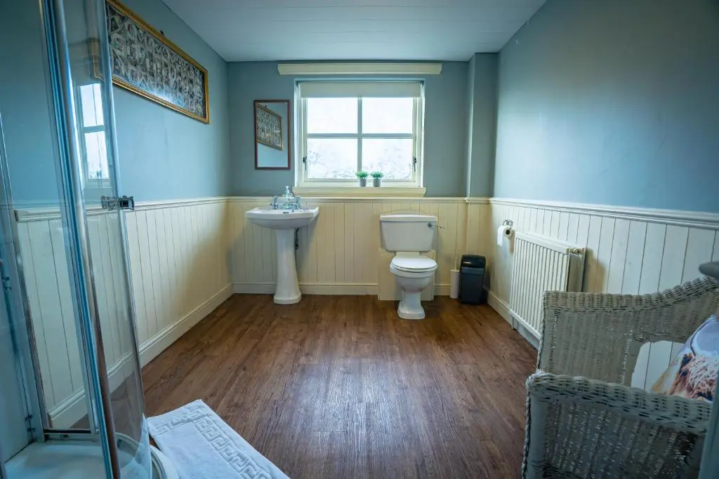 a bathroom with a toilet and a sink and a window at The Farmhouse, 6 bed property, Forres in Forres