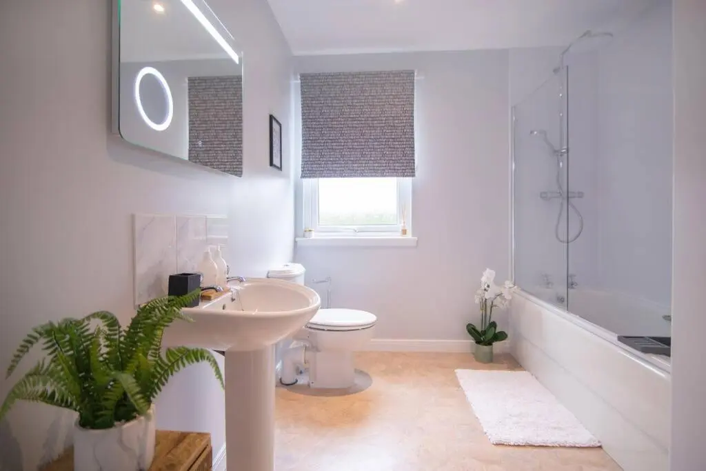 a bathroom with a sink and a toilet and a shower at Calm Scottish Country Escape with Hot Tub Sleeps 6 in Inverness