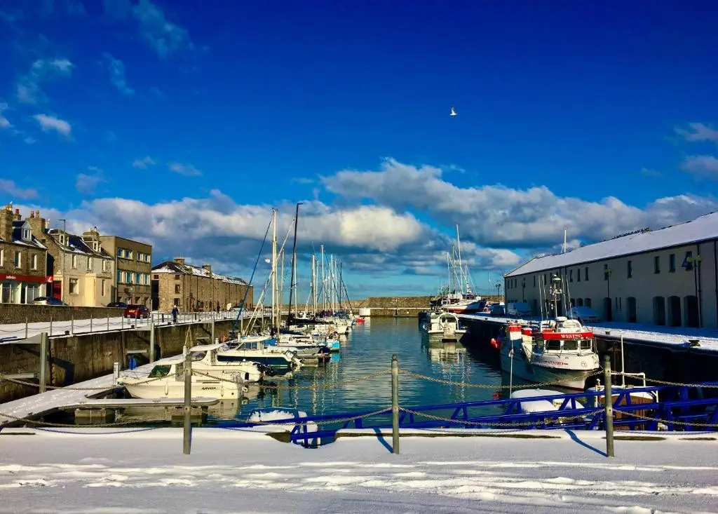 a group of boats docked in a harbor at Beachfront Panoramic Seaview Free Wifi & Parking in Lossiemouth