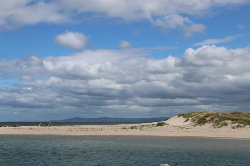 a view of a beach with a cloudy sky at Beachfront Panoramic Seaview Free Wifi & Parking in Lossiemouth