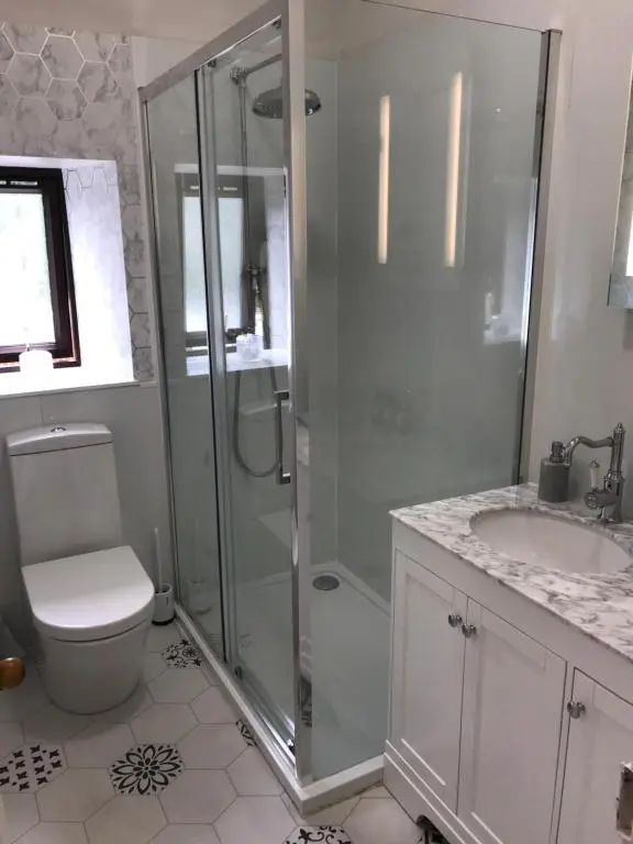 a bathroom with a shower and a toilet and a sink at Cavell House in Inverness