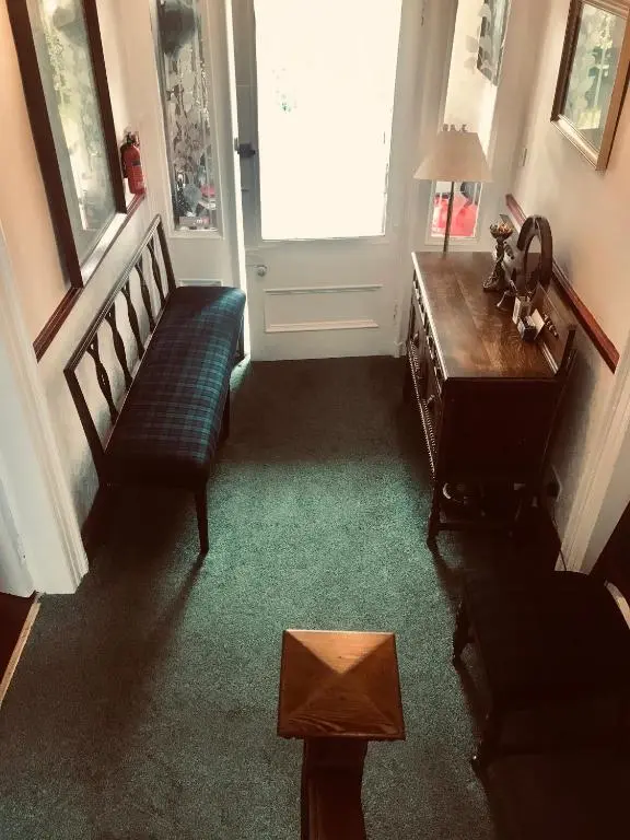 a living room with a couch and a chair at Cavell House in Inverness