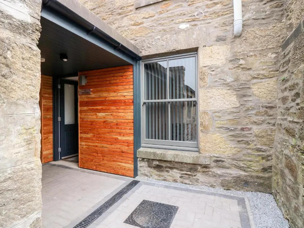an entrance to a building with a wooden door at The Marriage Room at The Institute Executive Apartments in Keith
