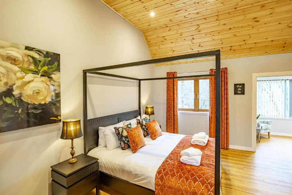 a bedroom with a bed in a room at Thistle Lodge 19 with Hot Tub in Belladrum