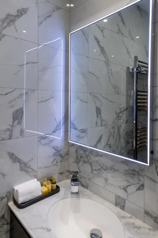 a bathroom with a sink and a mirror at Pamper yourself in our DOUBLE SIZED copper tub -2 bedroom villa in Inverness