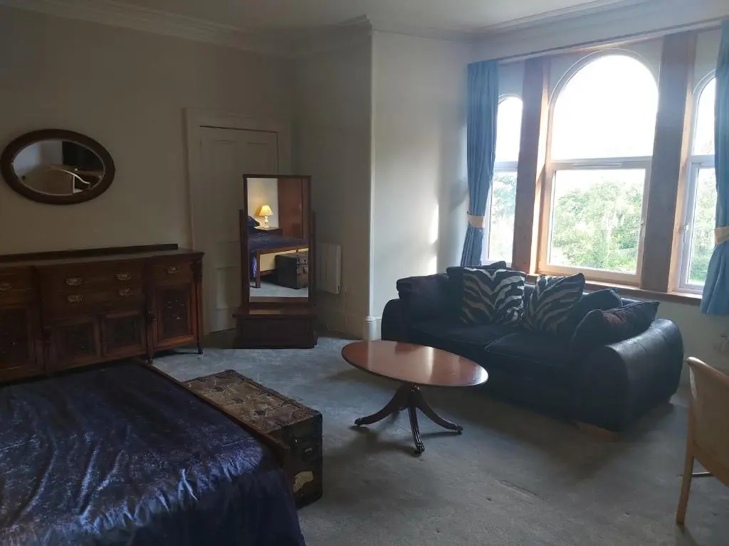 a living room with a couch and a table at Kirkhouse in Wick