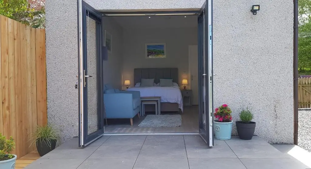 an open door to a bedroom with a bed at Fyrish View in Dingwall