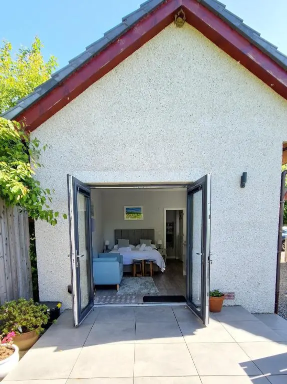 a door leading into a room with a bed at Fyrish View in Dingwall