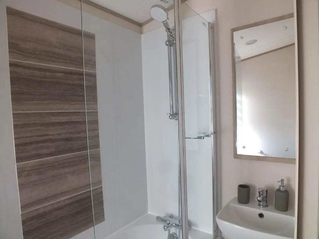 a bathroom with a shower and a sink at Beachside Lighthouse 14 in Lossiemouth