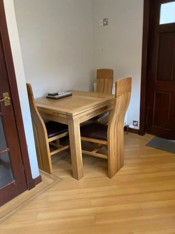 a wooden table and chairs in a room at No 22 in Banff
