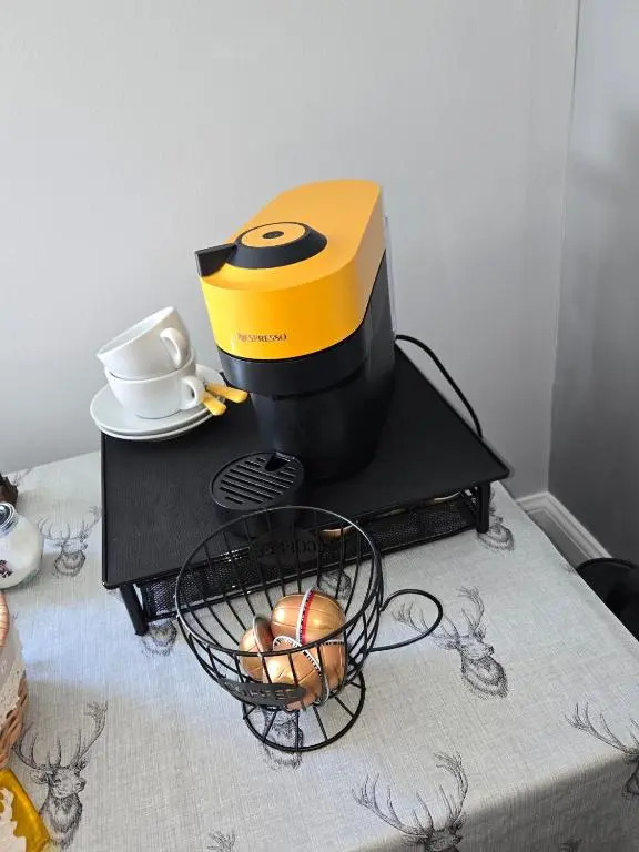 a yellow and black mixer sitting on a table at Beautiful studio chalet in the Highlands in Inverness