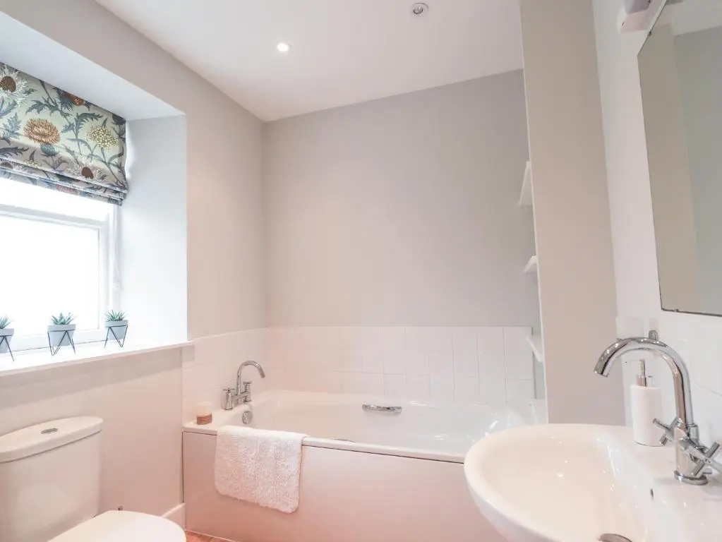 a white bathroom with a sink and a toilet at Garden House - Brodie Castle in Forres