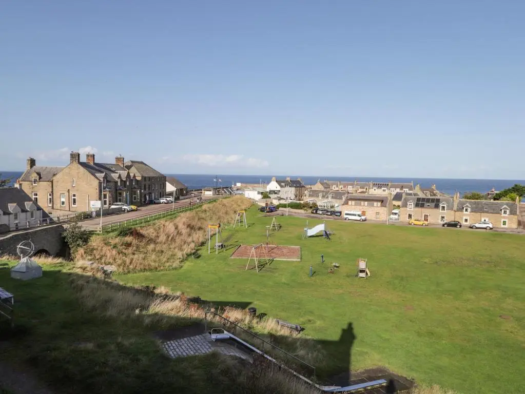a large grassy field with people in a town at Seaview at The Doocot in Elgin