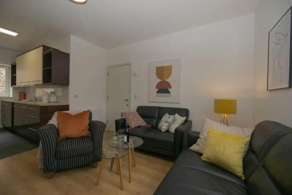 a living room with a couch and a table at Town centre 4xbed 4xbath apartment in Elgin