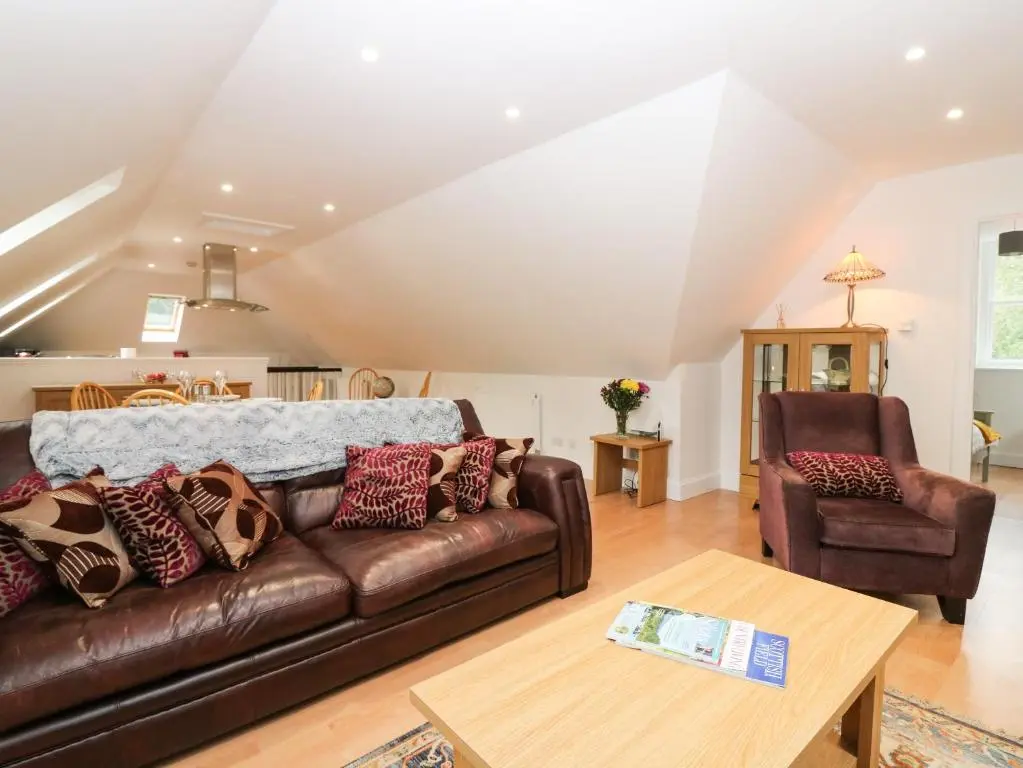 a living room with a couch and a table at Hayloft in Peterhead