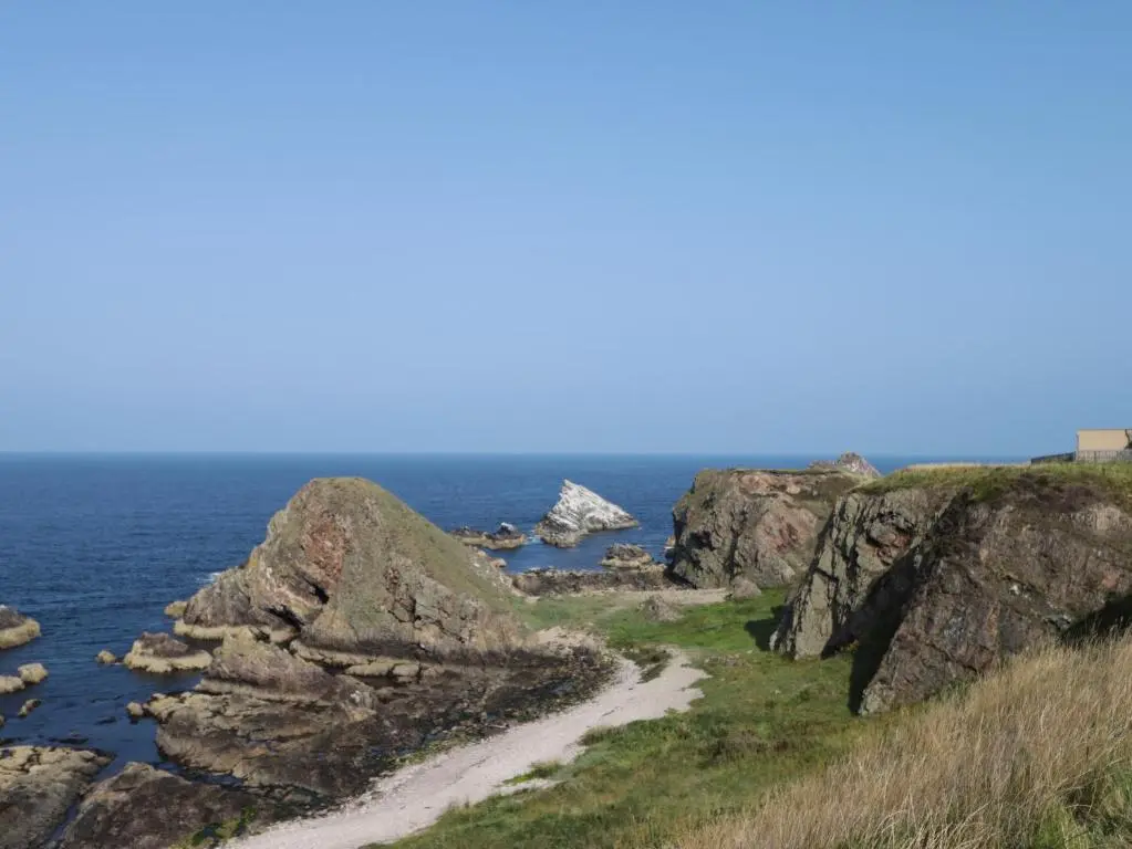 a dirt road on a cliff near the ocean at 18b New Street in Buckie