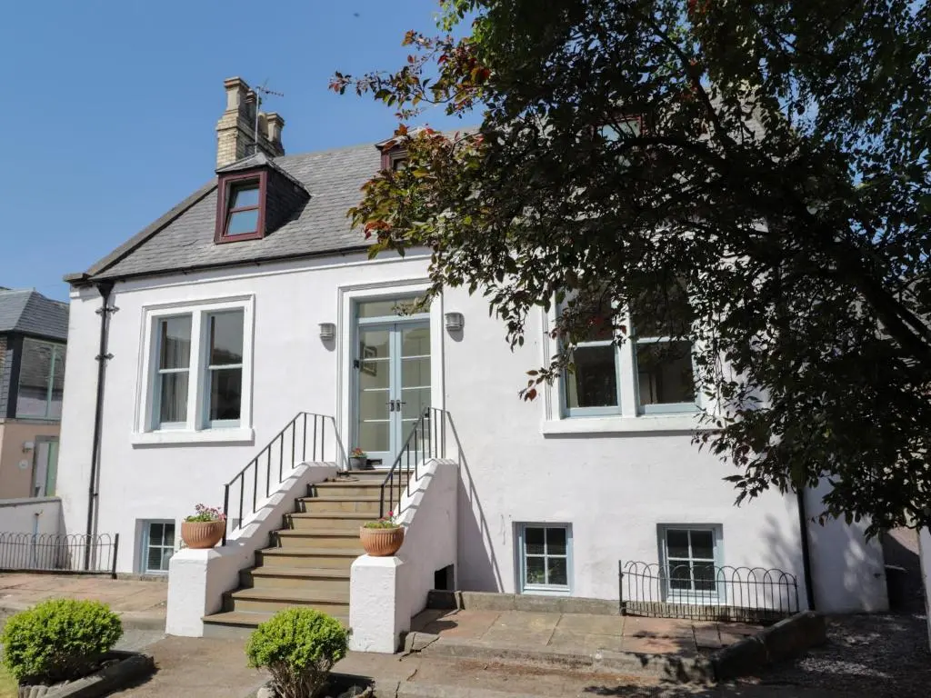 a white house with stairs in front of it at Mary Ann Villa in Inverness