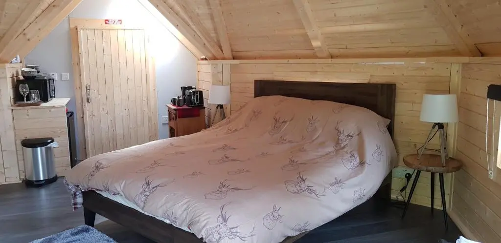 a bedroom with a bed in a wooden cabin at Unique luxury cabin in Inverness