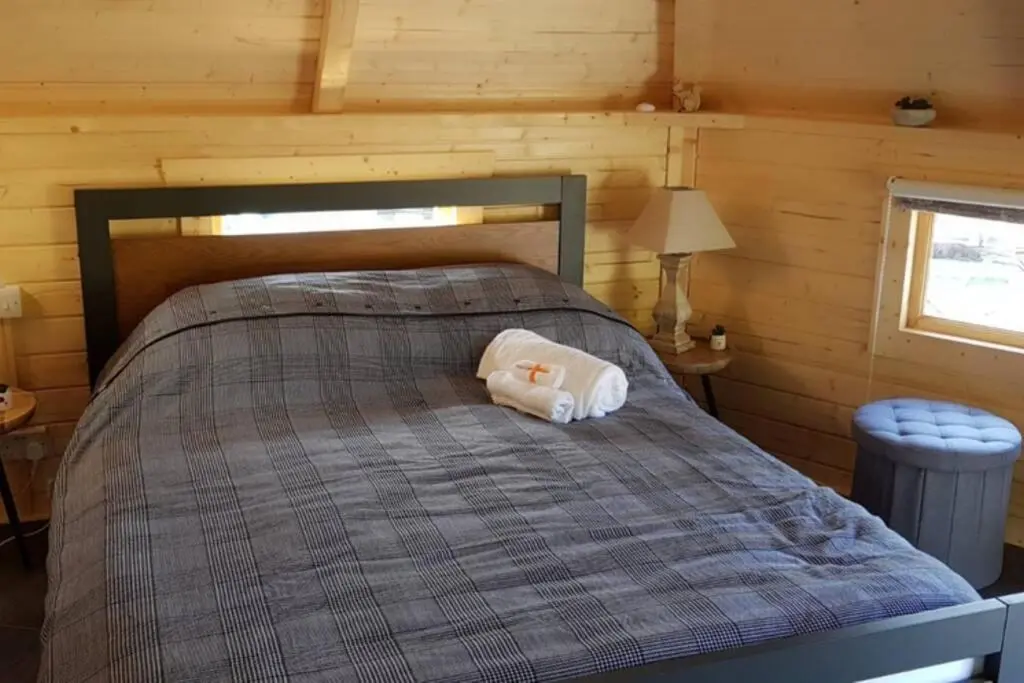 a bed with a stuffed animal on top of it at Unique luxury cabin in Inverness