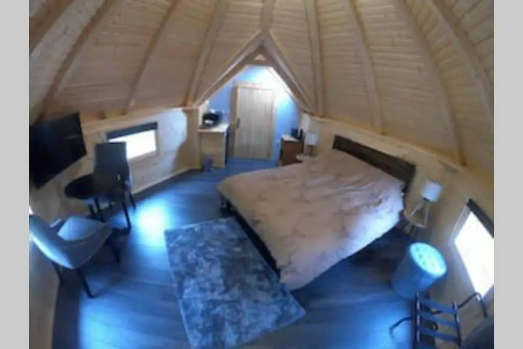 a bedroom with a bed and a desk in a room at Unique luxury cabin in Inverness