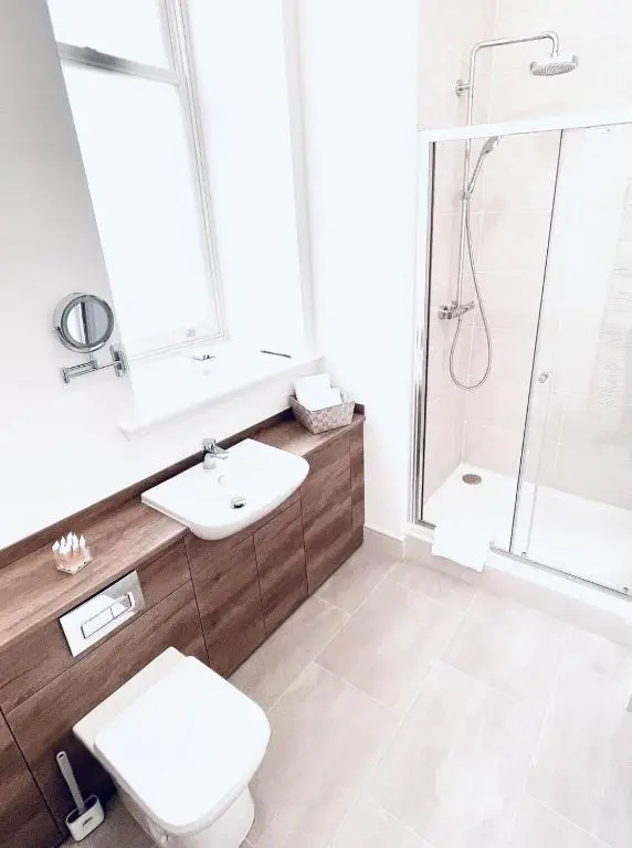 a bathroom with a toilet sink and a shower at No 49 a spacious executive apartment in Inverness in Inverness