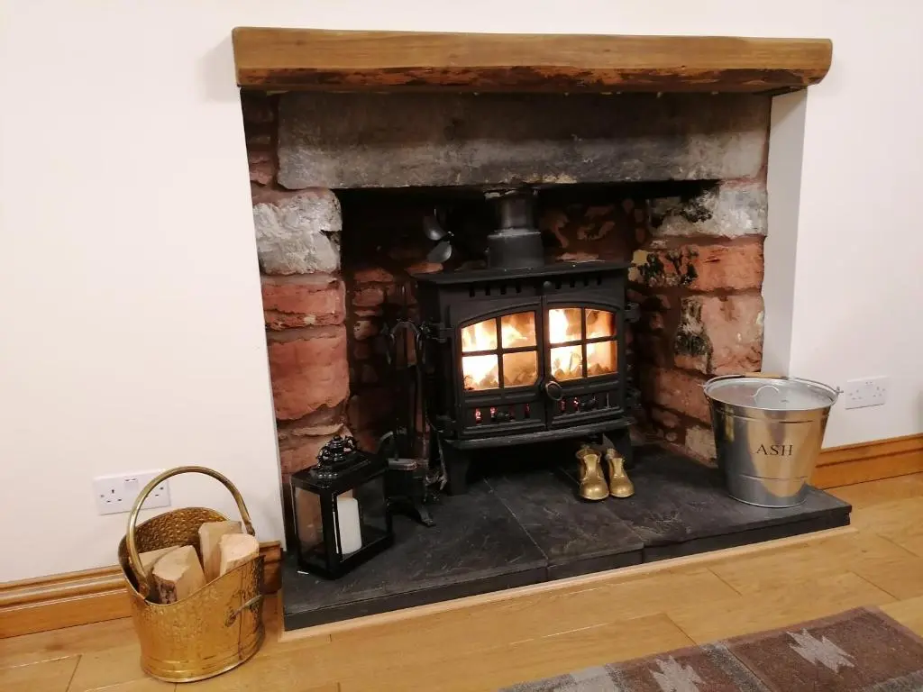 a fireplace with a fire in it in a room at Sunnyside House in Gardenstown