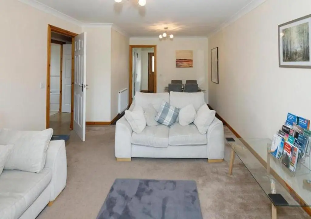 a living room with two white couches and a table at Modern 2 Bedroom Semi detached House with own private driveway in Inverness