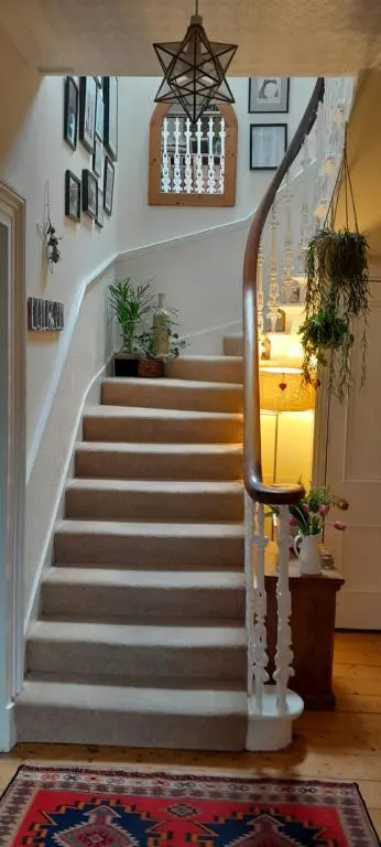 a staircase in a home with a stair case at Strome Lodge in Inverness