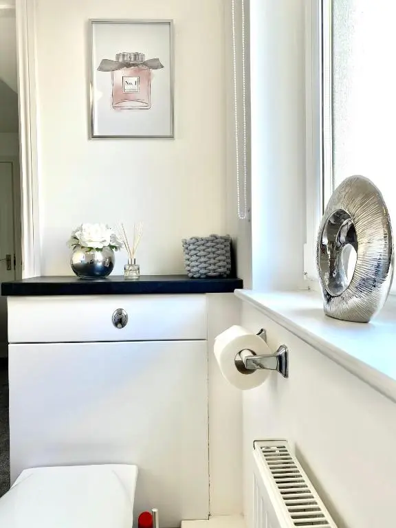 a white bathroom with a toilet and a mirror at Modern Spacious, Near Marina - Commerce Street, Lossiemouth - Free Parking, WiFi in Lossiemouth