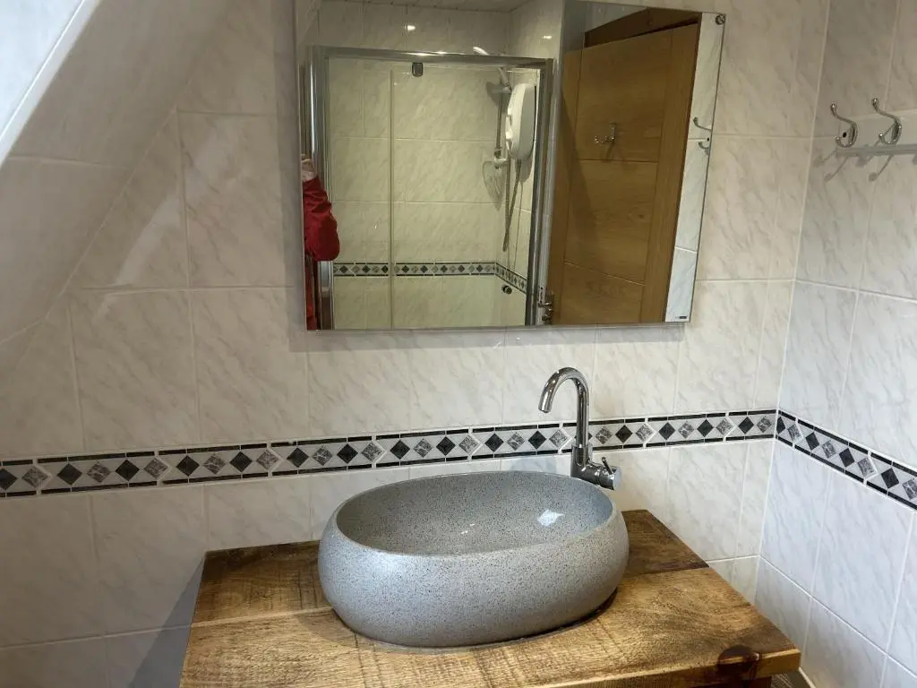 a bathroom with a sink and a mirror at Bright Star Lodge in Spean Bridge