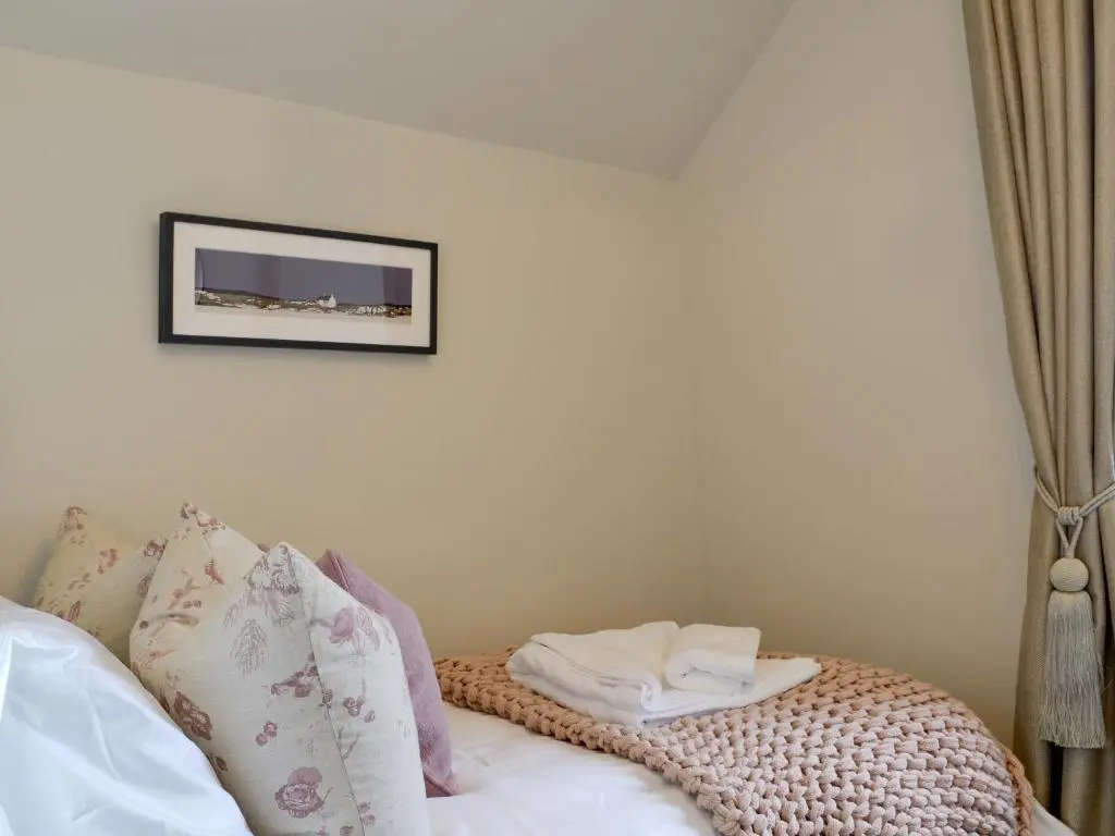 a room with a bed with a picture on the wall at Darroch View in Ballater