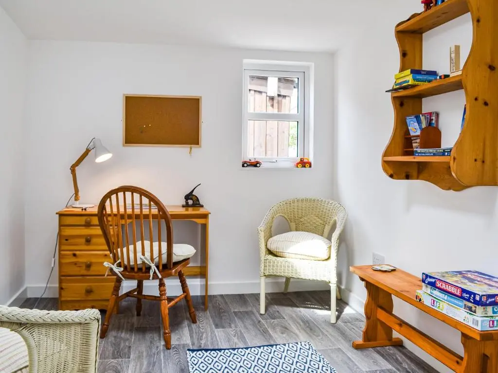 a room with a desk and a chair and a table at Needle Cottage in Cullen