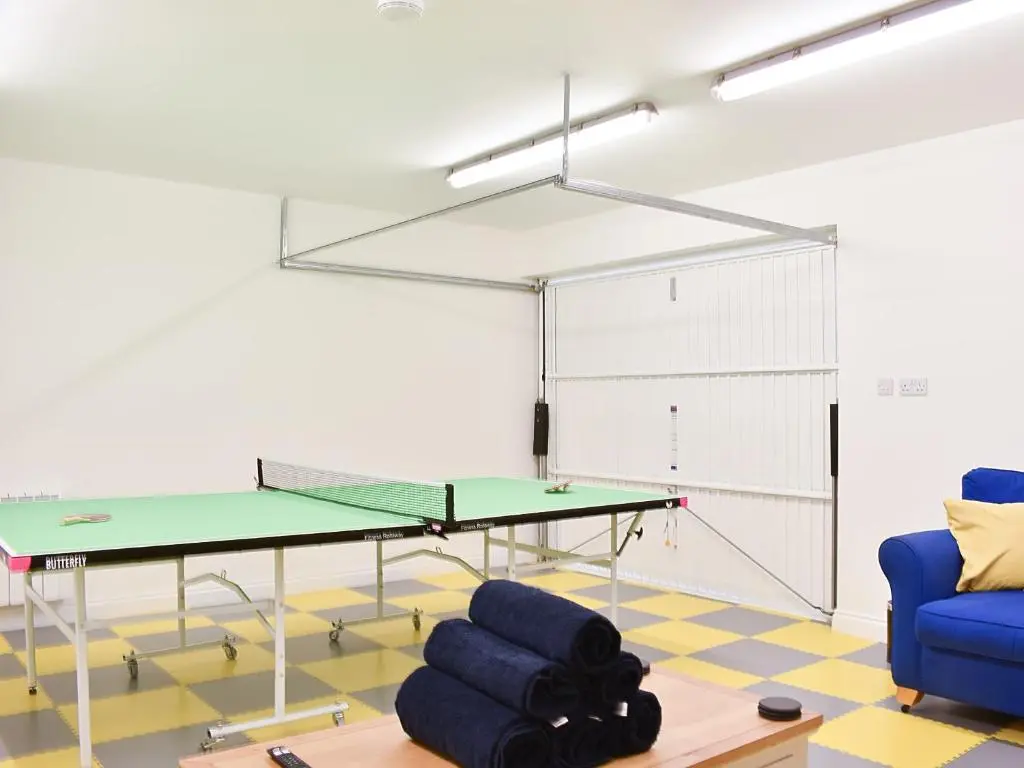 a ping pong room with a ping pong table at 1 Dalbuaick Farm Cottage in Carrbridge